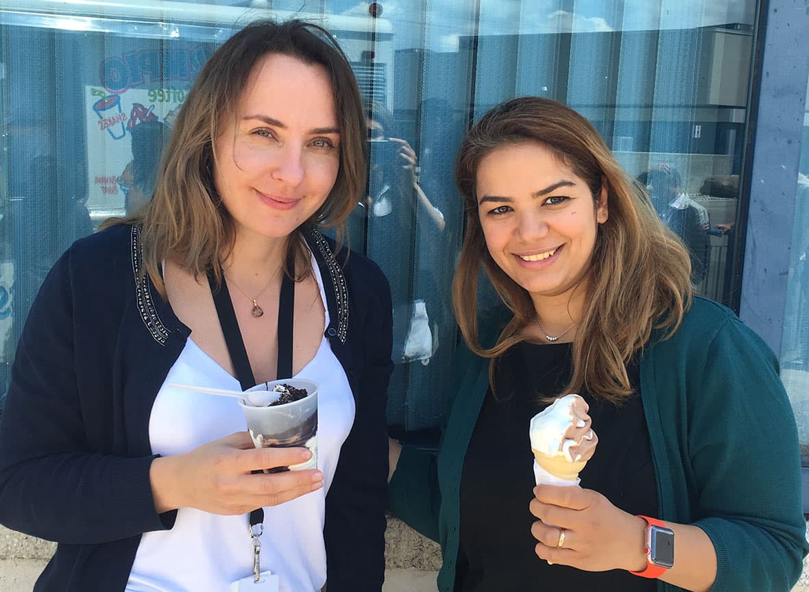 Two Asigra employees smiling and holding ice cream cones